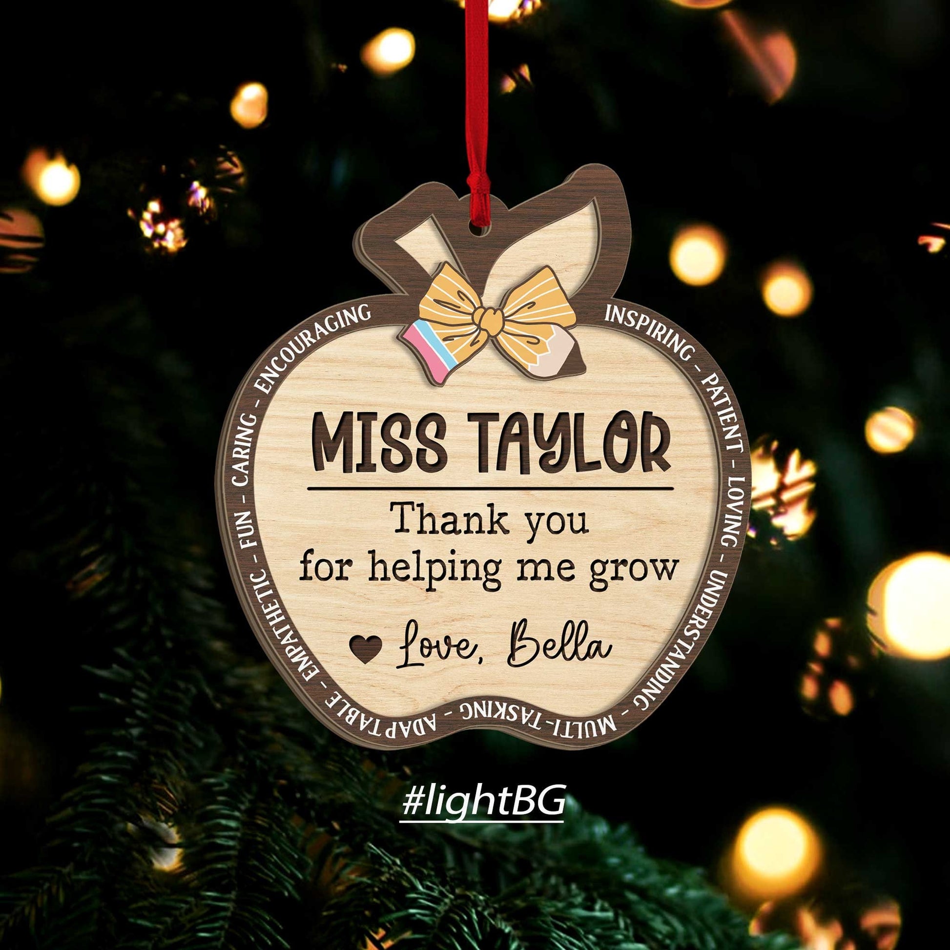 Charming apple-shaped ornaments featuring Miss Taylor’s name and a special note of gratitude from a student, Love, Bella. The combination of light or dark wood and a ribbon accent make these ornaments a perfect teacher’s gift.