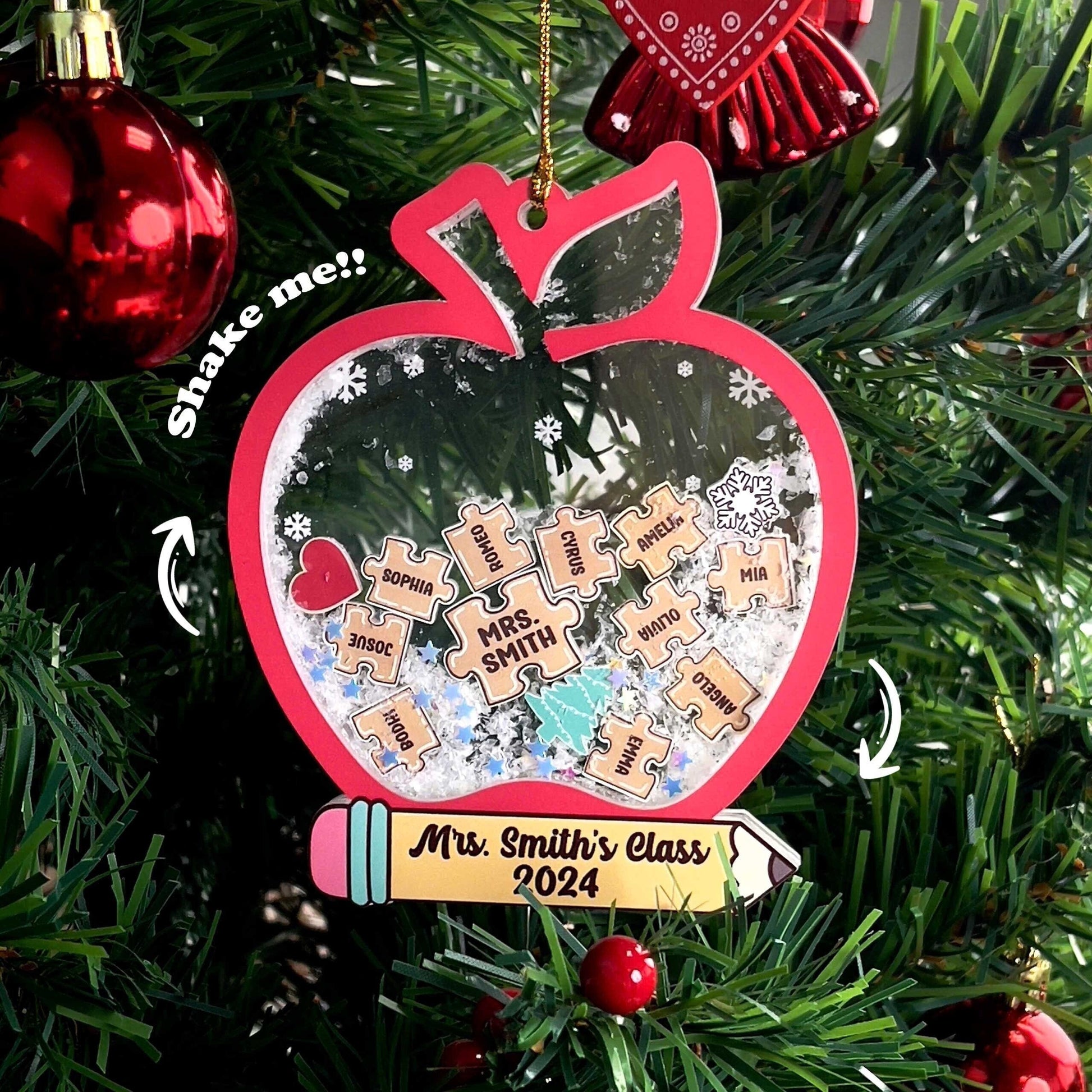 Adorable apple-shaped ornament personalized with Mrs. Smith’s Class 2024, featuring puzzle pieces with student names and a shakeable snow effect. A delightful keepsake for teachers to remember their class.