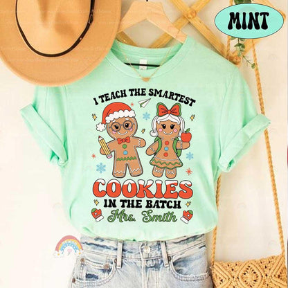 Charming shirt with a holiday-themed design featuring gingerbread cookies and a playful phrase, personalized for Mrs. Smith. A great gift for teachers this season.