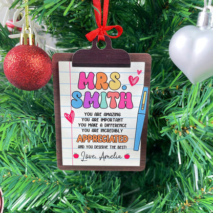 Festive ornament shaped like a clipboard, personalized with Mrs. Smith’s name and a message highlighting how important and appreciated she is. The personal touch from Love, Amelia makes it a meaningful keepsake.