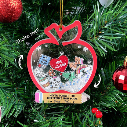 Playful and thoughtful ornament shaped like an apple with holiday-themed elements, including a personalized heart for Mrs. Wilson. With fun details like a snowflake and a pencil, this shakeable ornament is a perfect keepsake for teachers.