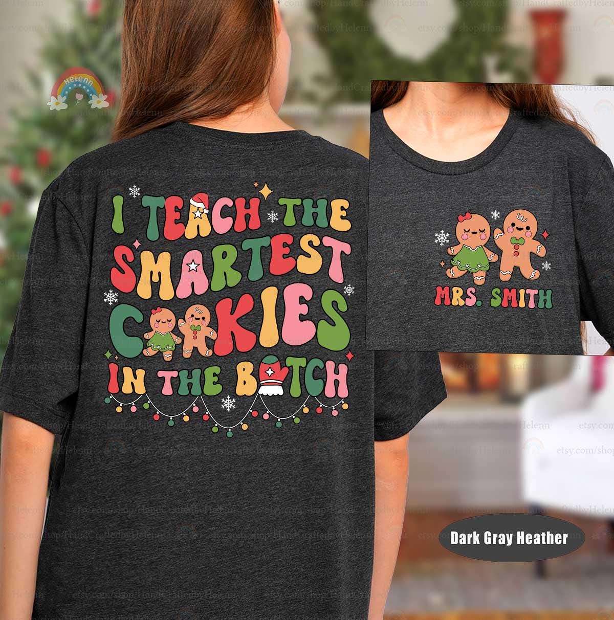 Joyful holiday shirt featuring colorful cookie designs and the phrase I Teach the Smartest Cookies in the Batch, perfect for Mrs. Smith to celebrate the season with her students.