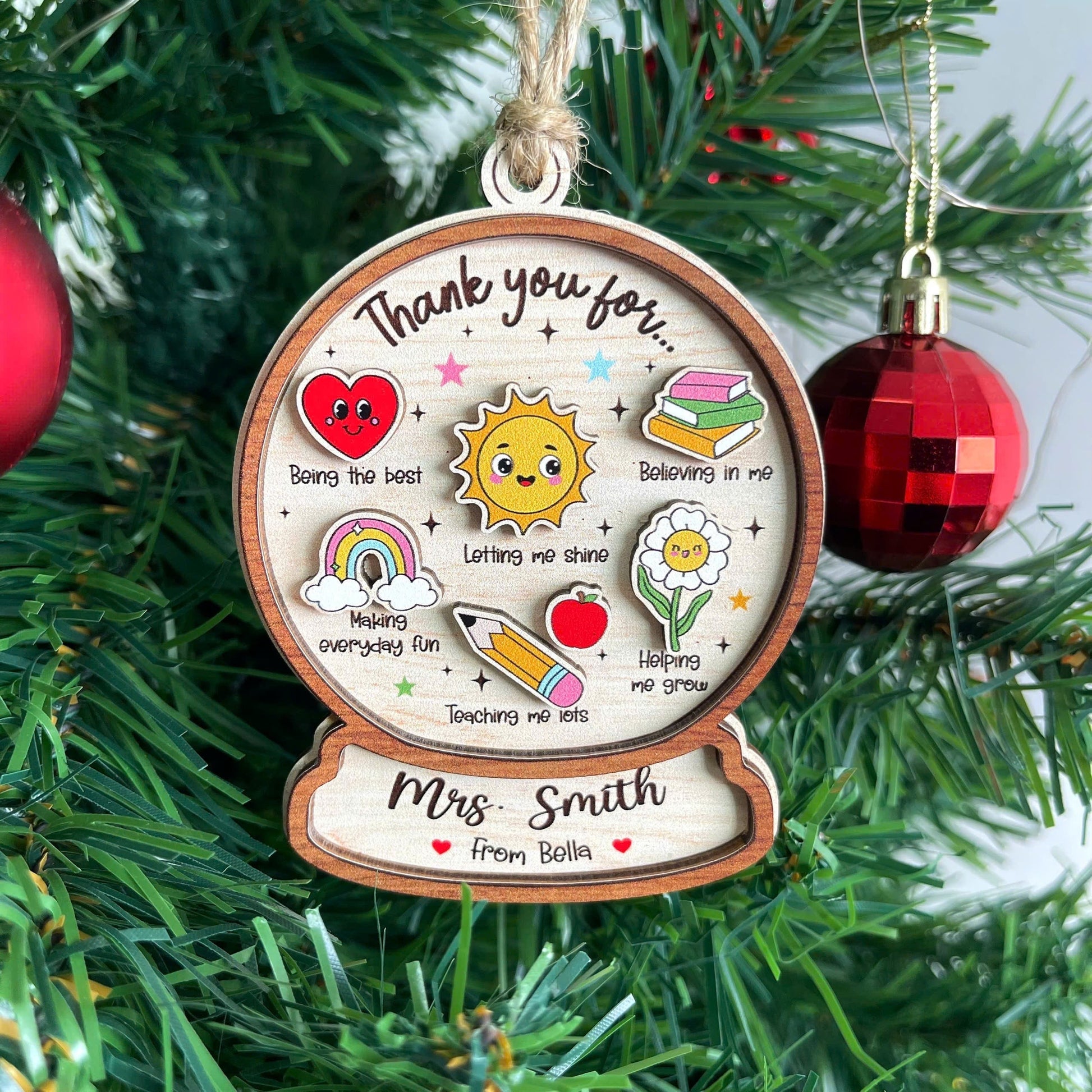 Charming ornament featuring colorful icons and a heartfelt thank-you message for Mrs. Smith, personalized from Bella. Each icon represents special traits like Believing in me and Helping me grow, making it a thoughtful teacher gift.