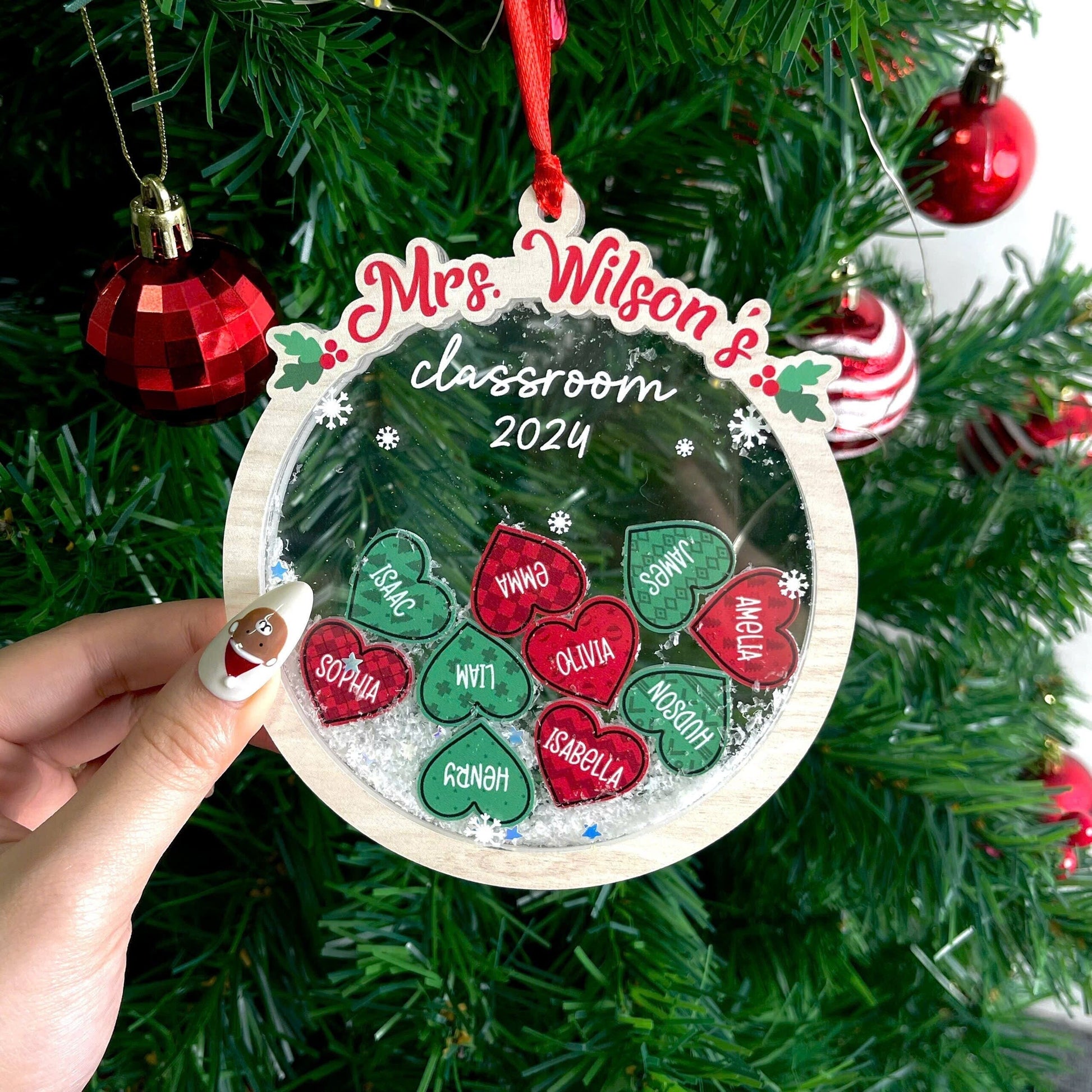 Festive classroom ornament featuring heart-shaped student names, personalized for Mrs. Wilson&#39;s classroom of 2024. A delightful holiday keepsake.