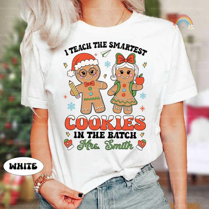 Festive shirt featuring cute gingerbread cookie characters, personalized with Mrs. Smith’s name and the fun phrase I Teach the Smartest Cookies in the Batch.