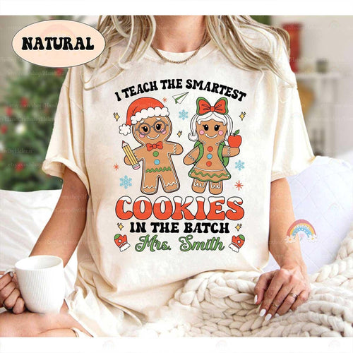 Playful holiday shirt featuring gingerbread characters and the phrase I Teach the Smartest Cookies in the Batch, personalized with Mrs. Smith’s name. A fun way to celebrate the season in the classroom.