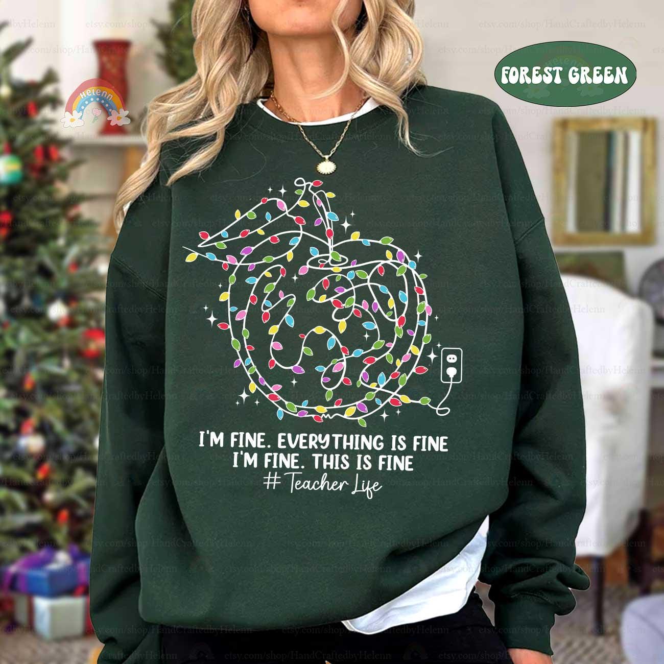 Relatable and festive, this design shows a classic teacher moment with lights and a humorous &quot;everything is fine&quot; message.