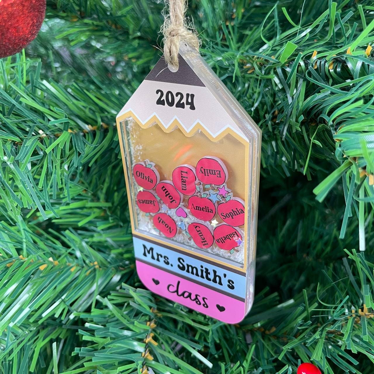 Perfect for any teacher, this pencil ornament holds apples with students&#39; names, a fun and personal classroom tribute.