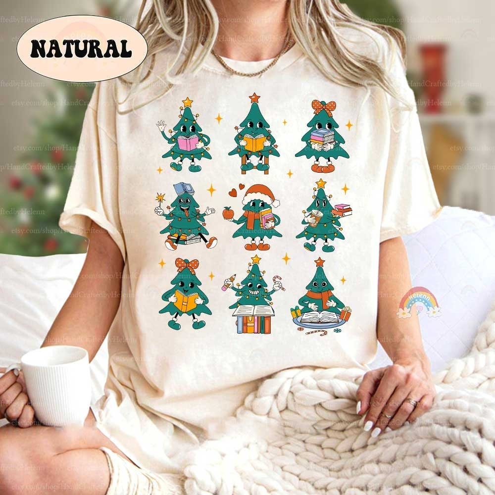 Cheerful and fun T-shirt featuring Christmas tree characters in various learning poses, surrounded by stars and festive elements. The playful design brings together education and holiday spirit.