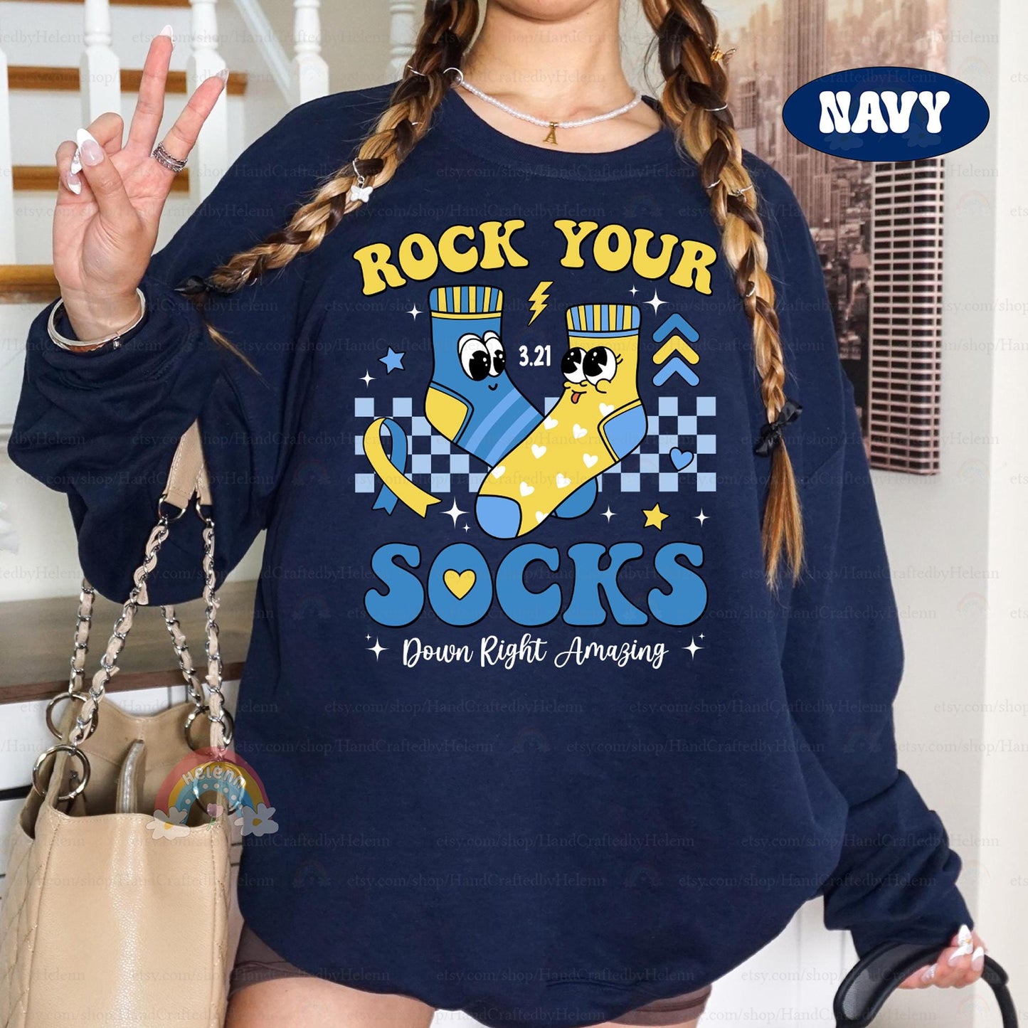 Show your support with this beautifully designed natural T-shirt. Featuring a joyful sock duo, awareness ribbon, and the inspiring &quot;Down Right Amazing&quot; message, it’s a reminder to celebrate individuality and kindness.