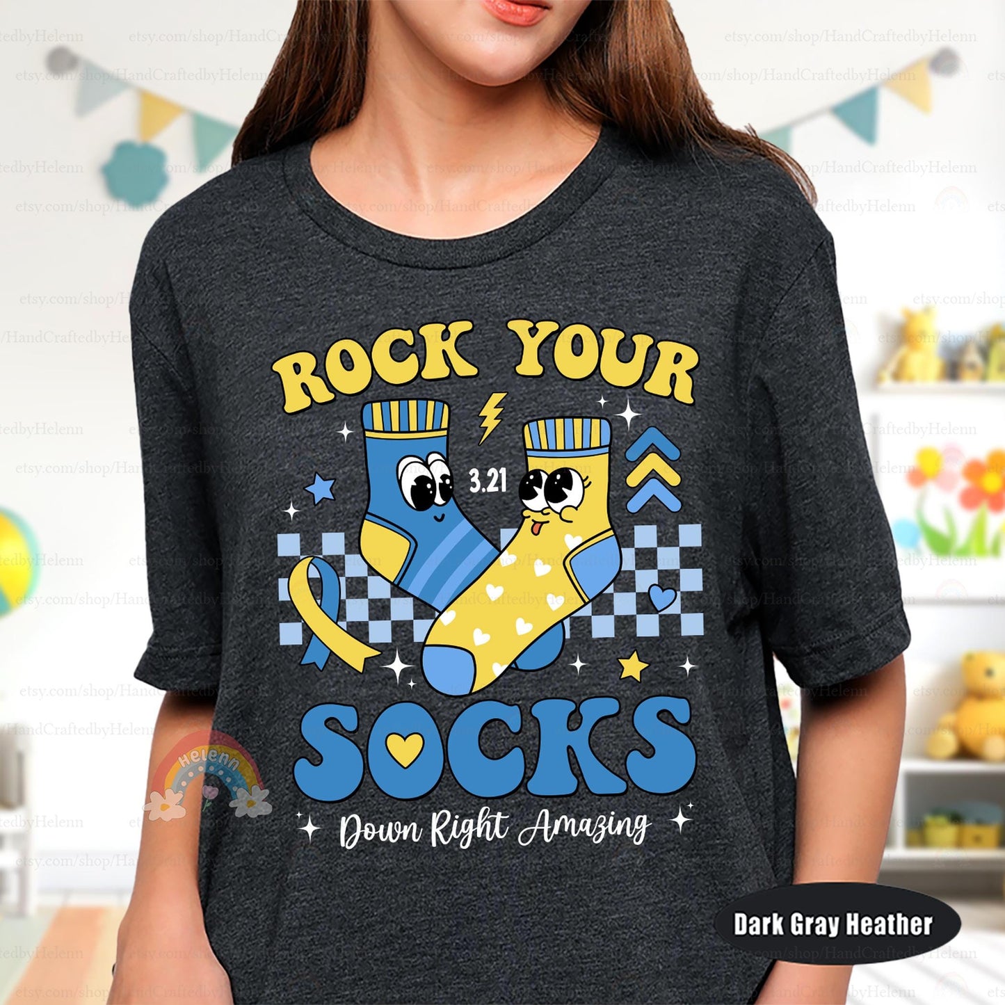 Spread joy with this fun and cozy T-shirt! A lively &quot;Rock Your Socks&quot; print, adorable sock characters, and a meaningful 3.21 reminder make it a great choice for expressing support and embracing differences in a bold way.
