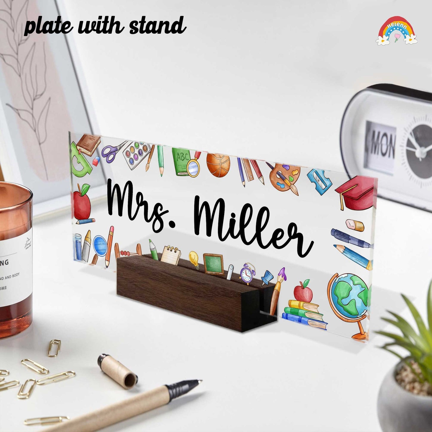 May include: Acrylic desk plate with stand, featuring a colorful school-themed design and the name &#39;Mrs. Miller&#39; in elegant calligraphy. The plate is rectangular and transparent, showcasing various school supplies such as pencils, books, and a globe. The stand is made of dark brown wood, providing a sturdy base for the plate. The overall theme is teacher appreciation or classroom decor.