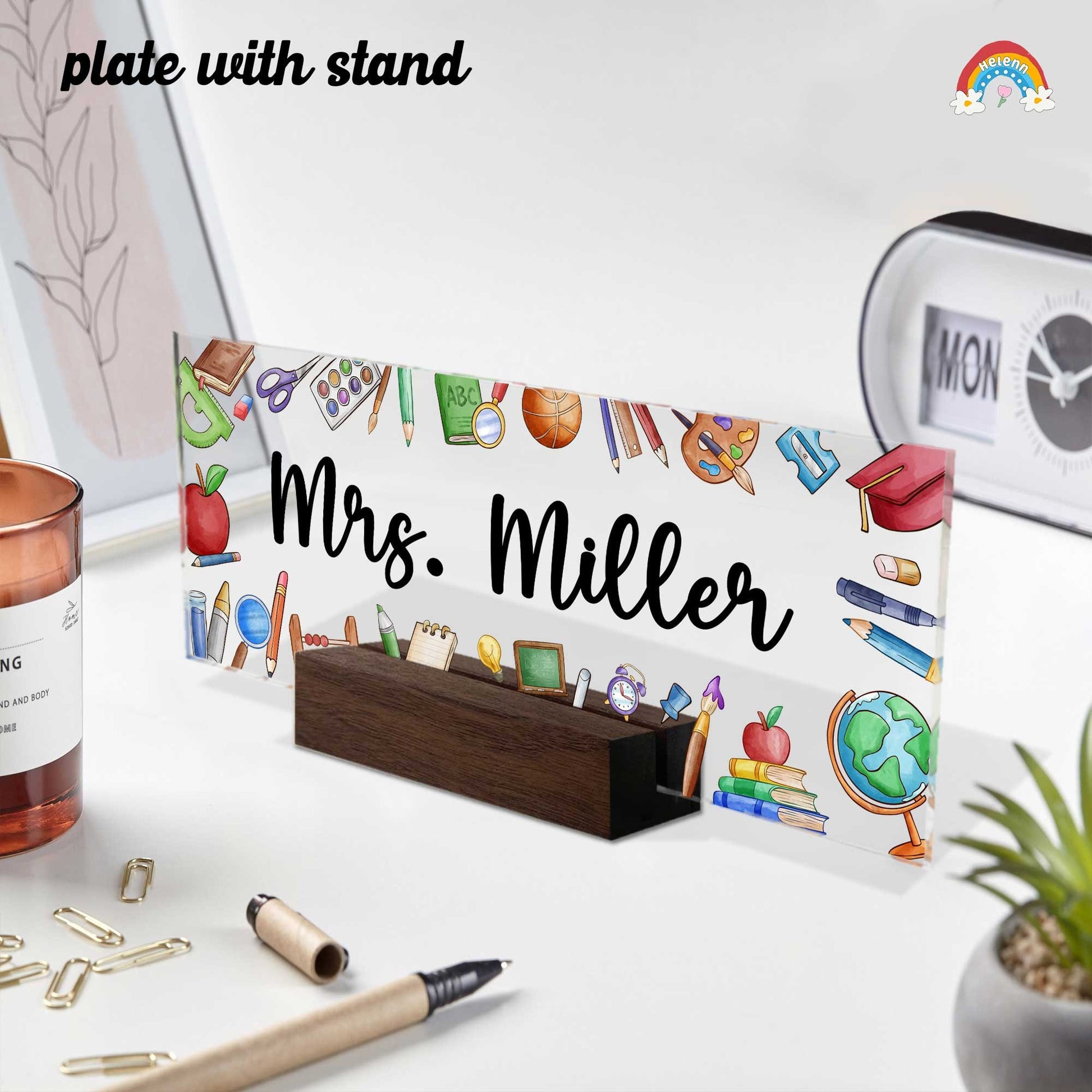 May include: Acrylic desk plate with stand, featuring a colorful school-themed design and the name &#39;Mrs. Miller&#39; in elegant calligraphy. The plate is rectangular and transparent, showcasing various school supplies such as pencils, books, and a globe. The stand is made of dark brown wood, providing a sturdy base for the plate. The overall theme is teacher appreciation or classroom decor.